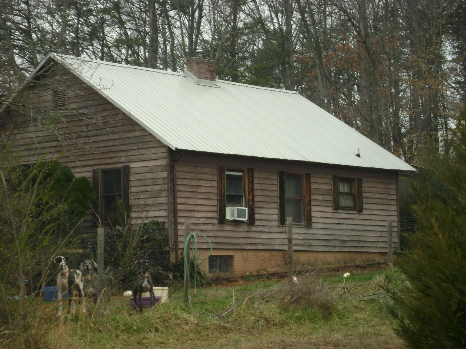 White metal roof on an old wood sided farmhouse, from a Metal Roof Installation job in Saltville